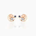 Detailed shot of rose gold star and moon teddy bear stud earrings with blue zirconia. - Blue Star Moon Bear Earrings (EH00628)