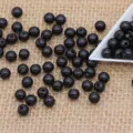 Black ABS plastic round beads variant style, double hole design for apparel accessories. - Black