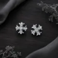 Detailed shot of sparkling gothic cross stud earrings with clear cubic zirconia stones. - White