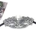 Close-up detail of silver lace masquerade mask with intricate embroidery and black ribbon ties. - Silver