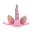 Detailed view of kids pink unicorn headband with glitter horn, floral decor and soft elastic band. - Pink