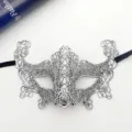 Detailed view of a silver lace masquerade eye mask with black ribbons for party and events. - Stamped Silver