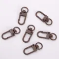 Brown metal swivel snap hooks for keychains, bags, and DIY crafts with spring gate design. - Dark Coffee