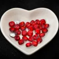Red and silver cushion cut rhinestones in heart dish for DIY nail art and clothing accessories. - Red
