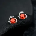 Close-up detail of snake shaped earrings with vibrant red bead, exquisite silver metal craft. - Eye of Medusa Earrings (Red) - Pair