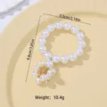 Élégant rond de serviette en perles blanches avec détail doré, déco de table chic, 5.5cm - Z1140