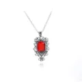Detailed view of the vintage ruby pendant necklace, showcasing intricate silver carved frame. - Red Jewel Angel Pendant Style (A1056)
