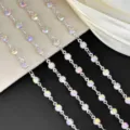 Close-up detail of sparkling AB crystal rhinestone cup chains, showing colorful multi-faceted stones. - AB Silver