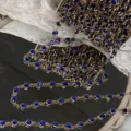 Detailed closeup view of 6mm blue rhinestone chain, antique style DIY craft accessory. - Sapphire Blue