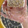 Close-up detail of silver DIY rhinestone chain with sparkling yellow crystals for crafts. - Silver / Yellow