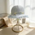Sweet light blue baby bucket hat featuring mesh fabric, cute bows, lace edges and floral details. - M / Blue
