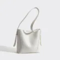 Minimalist white bucket bag with long shoulder strap, casual versatile large capacity design. - White