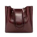 Detailed view of wine red oil leather tote bag, soft texture and dual shoulder handles. - Burgundy