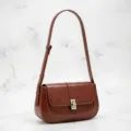 Vintage brown leather shoulder bag with metal turn lock and contrast white stitching. - Tan
