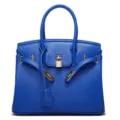 Blue leather handbag with metal lock and top handles, stylish fashion tote bag for daily use. - Blue