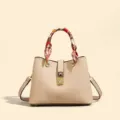 Fashionable niche design beige tote bag with chic silk scarf handle and metal lock detail. - White