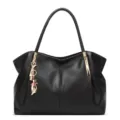 Black PU leather shoulder tote bag, elegant minimalist dumpling bag with gold cat charm. - Black