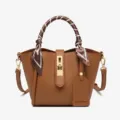Brown leather bucket bag with top handle, scarf wrap and metal lock for women daily commute. - Tan