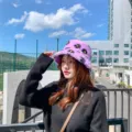Trendy purple plush bucket hat with cute black daisy pattern, warm cozy winter headwear. - M (56-58cm) / Purple