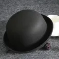 Detailed view of the black wool bowler hat, showcasing the classic dome shape and texture. - Adult / Black