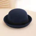 Detailed view of dark blue wool felt bowler hat with black band, autumn winter fashion accessory. - Navy Blue