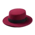 Detail view of a stylish wine red wool flat top hat with black ribbon band close up. - One Size / Burgundy