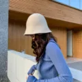 Detail view of a cozy knit bucket hat for women in beige, soft winter headwear style. - M (56-58cm) / Apricot