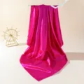 Detail view of smooth magenta silk scarf draped over decor, highlighting glossy fabric texture. - 90cm X 90cm / Rose Red