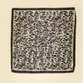 Detailed shot of abstract animal print silk scarf showing fine texture and dark border design. - Yellow Leopard Style / Yellow