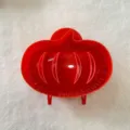Red plastic fall hand pie mold detail view, ideal for baking seasonal fruit and apple pastries. - Pumpkin