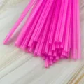 Bright pink plastic drinking straws detail view, bulk pack disposable colorful tubes. - Pink