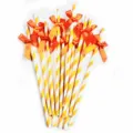 Detail view of decorative paper drinking straws featuring vibrant orange bows for party setup. - Orange Striped Bow Straws