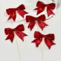 Red satin bow cake toppers detail view, perfect for wedding, birthday, and party dessert decorations. - Burgundy