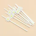 Detail view of white paper drinking straws with cute daisy flower card decor for party. - Small Flowers & Pure White Straws
