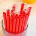 Red heart shaped plastic drinking straws with individual packaging for party and wedding decor. - Heart-Shaped Straws - Red (Individually Wrapped)