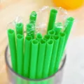 Green heart-shaped plastic drinking straws with individual packaging for parties and drinks. - Heart-Shaped Straws - Green (Individually Wrapped)
