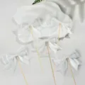 White bow cake topper detail view, elegant ribbon dessert decoration for party baking. - White