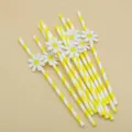 Close up of yellow striped paper straws with cute white daisy decorations for party events. - Small Flowers & Yellow Striped Straws