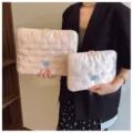 Detail shot of Korean style quilted satin laptop sleeve with cute bow embroidery for women - 11" / Pink