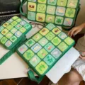 Green felt laptop sleeve featuring aesthetic illustration grid design for daily use. - Horizontal Medium Size / Green