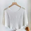 Detailed view of the white knitted hollow-out shawl, showcasing delicate crochet pattern. - White with Brooch