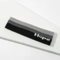 Cinta deportiva de punto con rayas tricolores y diseno Hope para entrenamientos. - Bloque de color negro y gris Hope