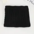 Detailed close-up of a black knitted neck warmer, showing soft cable knit texture and warm fit. - No. 7 Black Large & Small Cable Knit