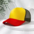 Color-blocked trucker hat detail showing bright yellow front and red brim on white display stand. - M (56-58cm) / Red + Yellow