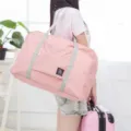 Pink foldable travel duffel bag detail view, large capacity waterproof luggage storage bag. - Large / Pink