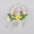 Easter decoration wreath with colorful eggs, faux flowers, and ribbons for spring window display. - Style 22