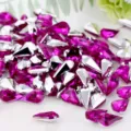 Drop-shaped acrylic point-back rhinestones detail view, vibrant pink sparkle gems. - Purple Fuchsia