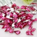 Close-up detail view of pink waterdrop acrylic rhinestones, ideal for DIY crafts decoration. - Rose Red