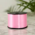 Detail view of pink balloon ribbon spool, perfect for wedding decoration and gift wrapping - Pink