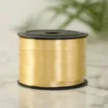 Gold ribbon roll on black spool for balloon decoration, gift packaging, and wedding details. - Gold